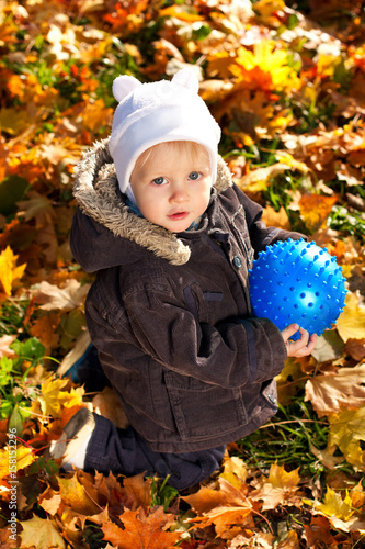 Cute child played with a blue ball in his hands
