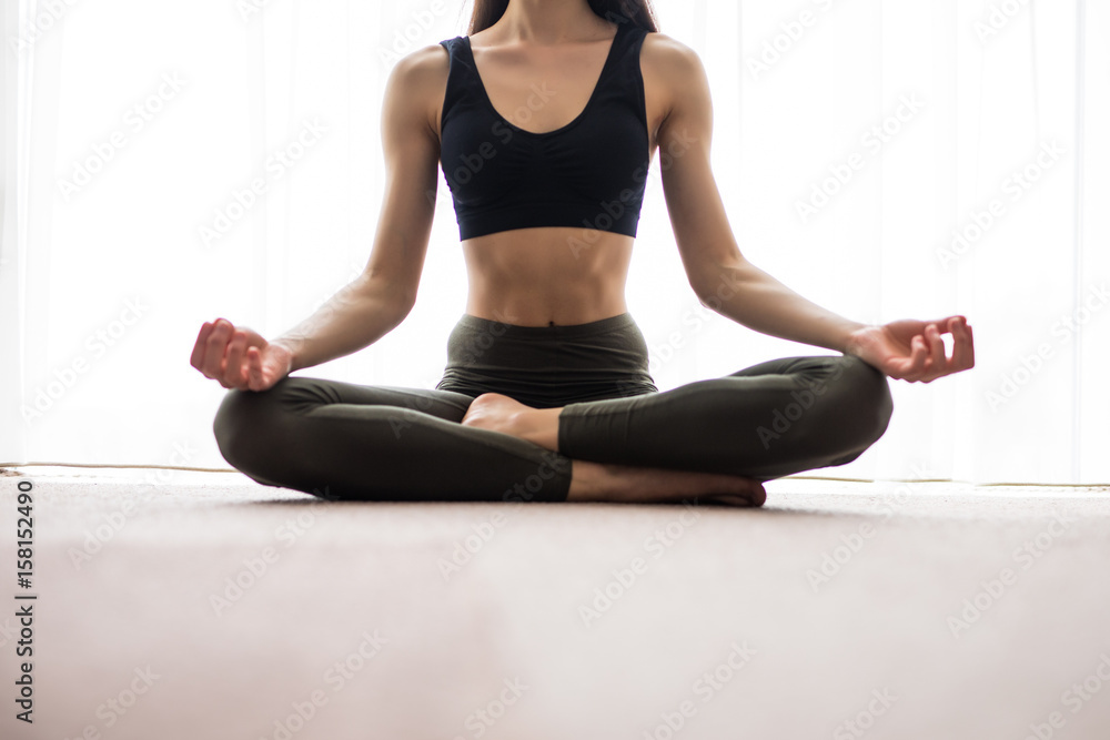 Yoga meditation at home. Relax concept with unrecognizable spiritual young woman sitting. Caucasian concentrating model. Copyspace. Yoga meditation at home. Relax concept with unrecognizable spiritual young woman sitting. Caucasian concentrating model. Copyspace.
