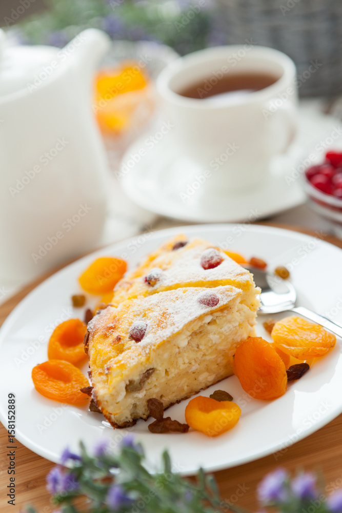 Cheese cake with tea, dried apricot and raisins closeup on a plate Cheese cake with tea, dried apricot and raisins closeup on a plate