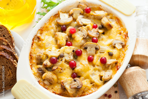 Baked vegetables pie with sliced mushrooms, potatoes, cranberries and cheese