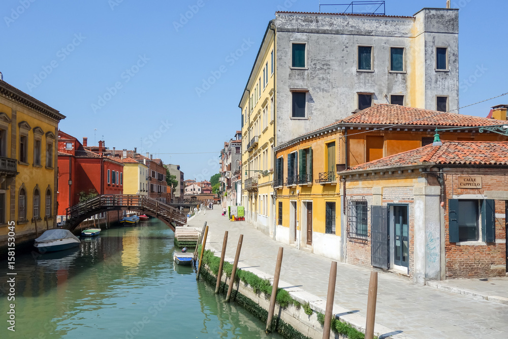 VENICE, ITALY - May 18, 2017.View of water street and old buildings in Venice on May 18, 2017. its entirety is listed as a World Heritage Site, along with its lagoon