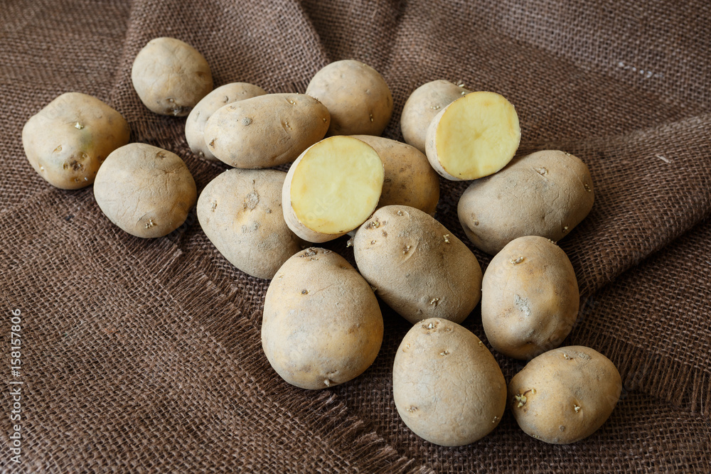 Old potato with young sprouts on a wooden table ready for planting Old potato with young sprouts on a wooden table ready for planting