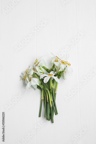 Daffodils flowers bouquet on white painted background