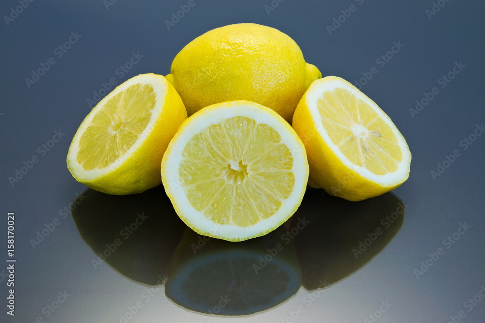 Fresh and ripe lemons on a reflective surface Fresh and ripe lemons on a reflective surface