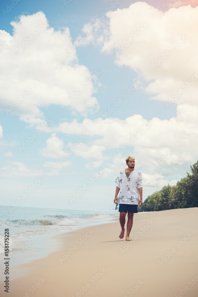 Young man walk alone on the beach. Young man walk alone on the beach.
