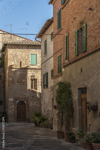 Fototapeta Naklejka Na Ścianę i Meble -   Beautiful narrow street in the small magical and old village of Pienza, Val D'Orcia Tuscany - Italy