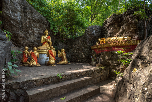 Statues of Buddha and his disciples in the woods 