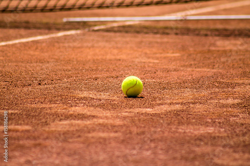 Tennis ball on the dirt court © kvdkz