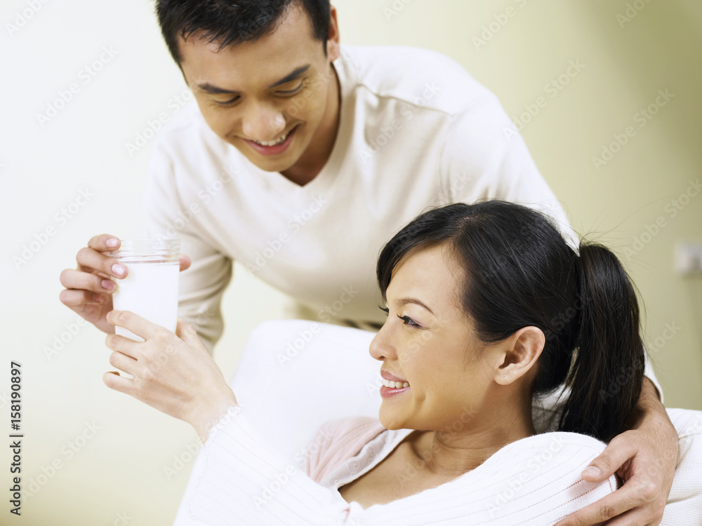man bring pregnant wife a glass of milk