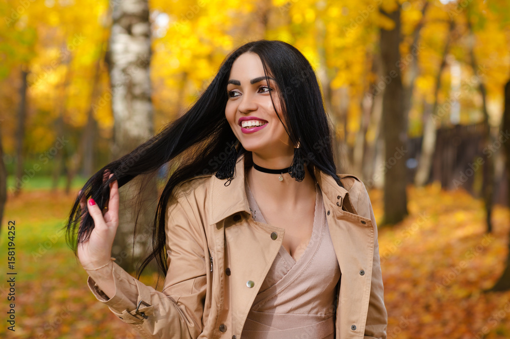 charming smiling brunette on background of autumn park charming smiling brunette on background of autumn park