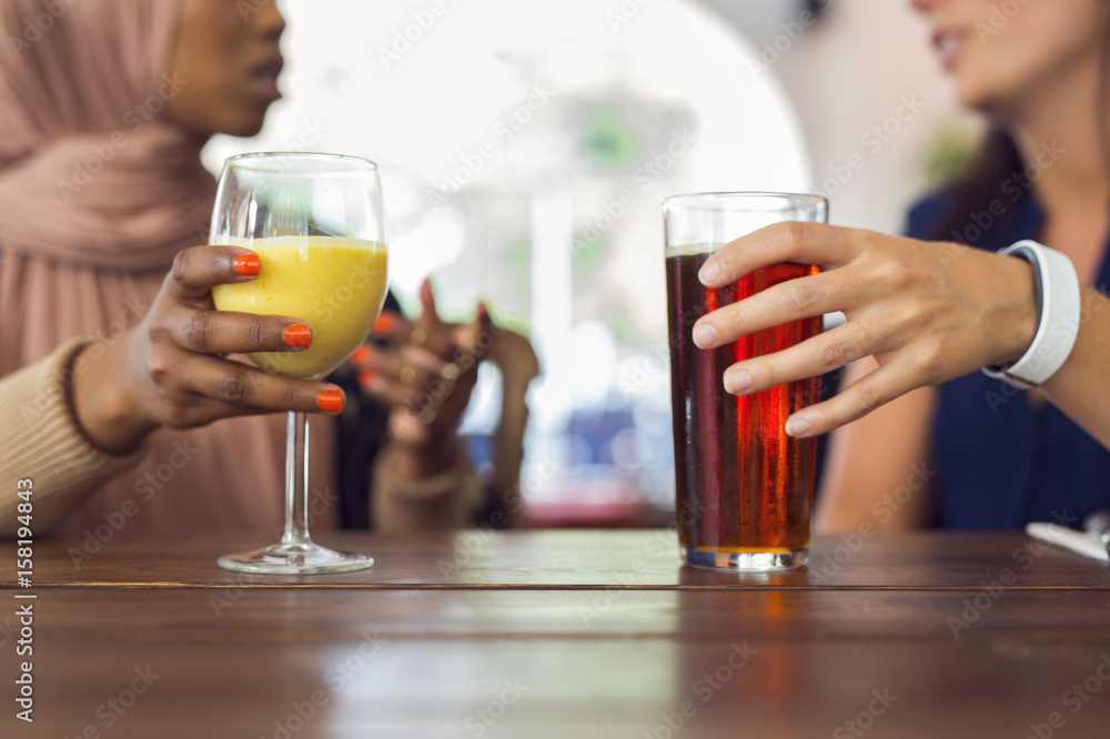 Businesswomen talking and drinking juice Businesswomen talking and drinking juice