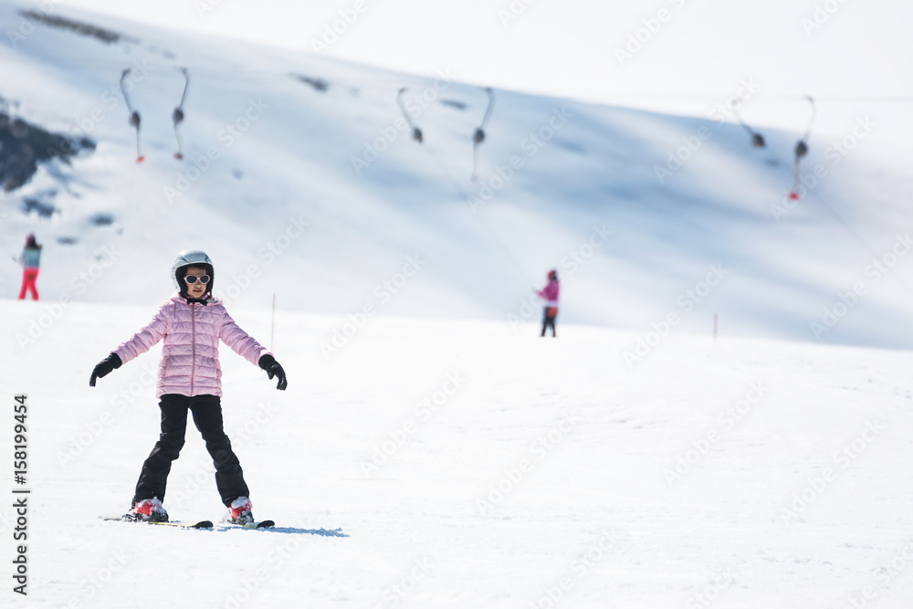 Beginner little girl learning to ski