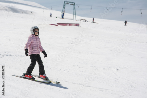 Beginner little girl learning to ski