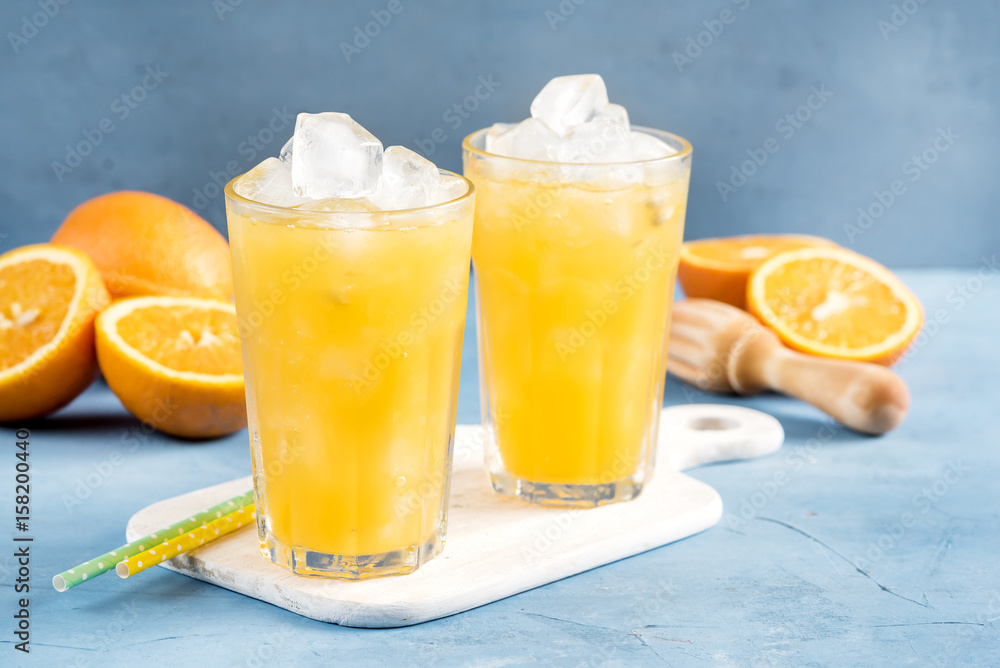 Glass of orange juice with ice cubes Cold orange fresh Glass of orange juice for hot summer day Glass of orange juice with ice cubes Cold orange fresh Glass of orange juice for hot summer day