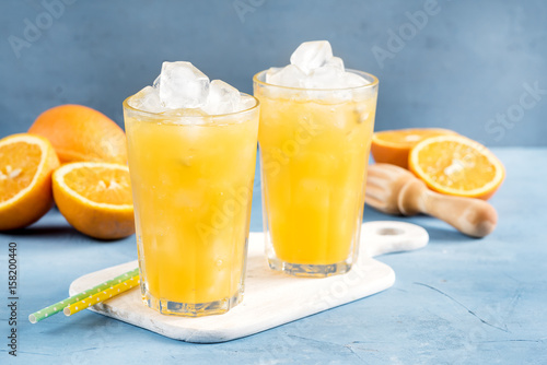 Glass of orange juice with ice cubes Cold orange fresh Glass of orange juice for hot summer day