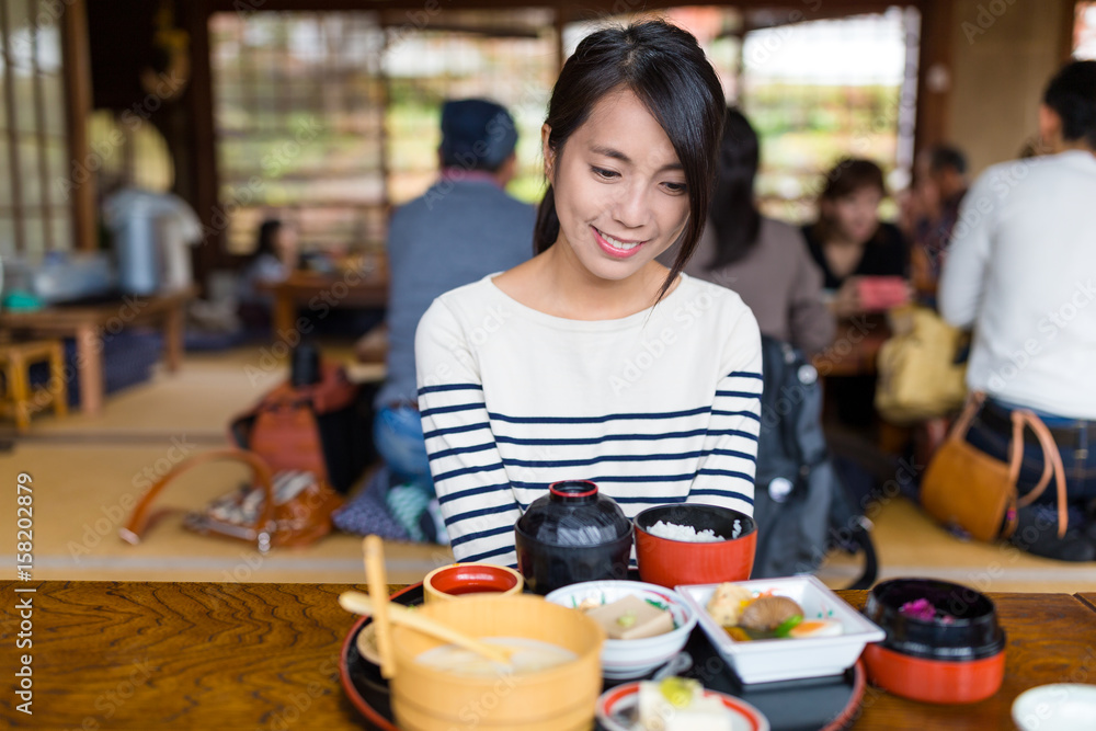 Woman enjoy japanese cuisine in restaurant