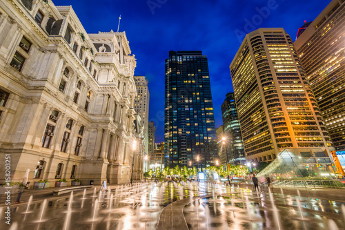 Fountains at Dilworth Park and modern buildings in Center City at night, in Philadelphia, Pennsylvania.