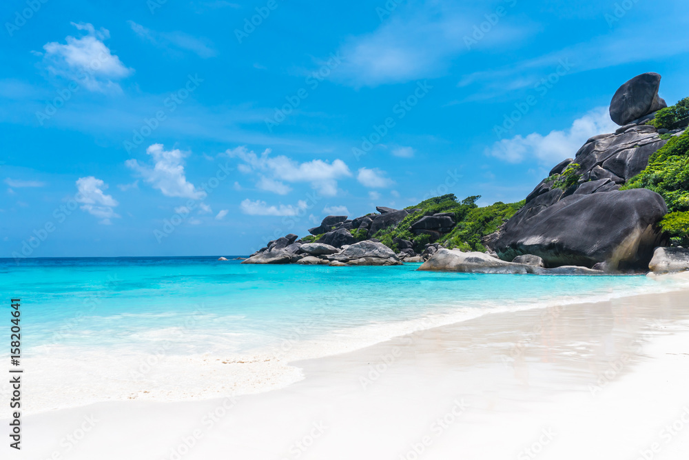 Beautiful view with blue sky and clouds, blue sea and white sand beach on Similan island, No.8 at Similan national park, Phuket, Thailand is most popular vacation for tourist.