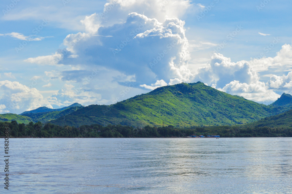 Mid-Mekong River Mountain sky clouds Luang Prabang, Laos.