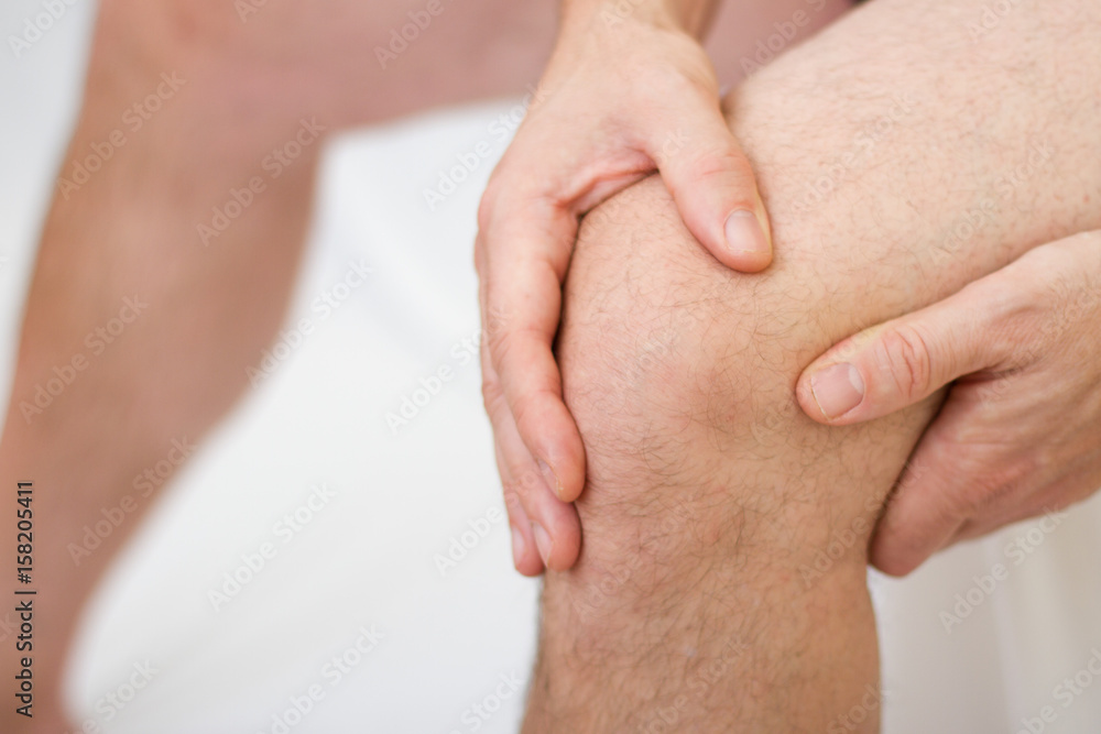 Man holding his knee