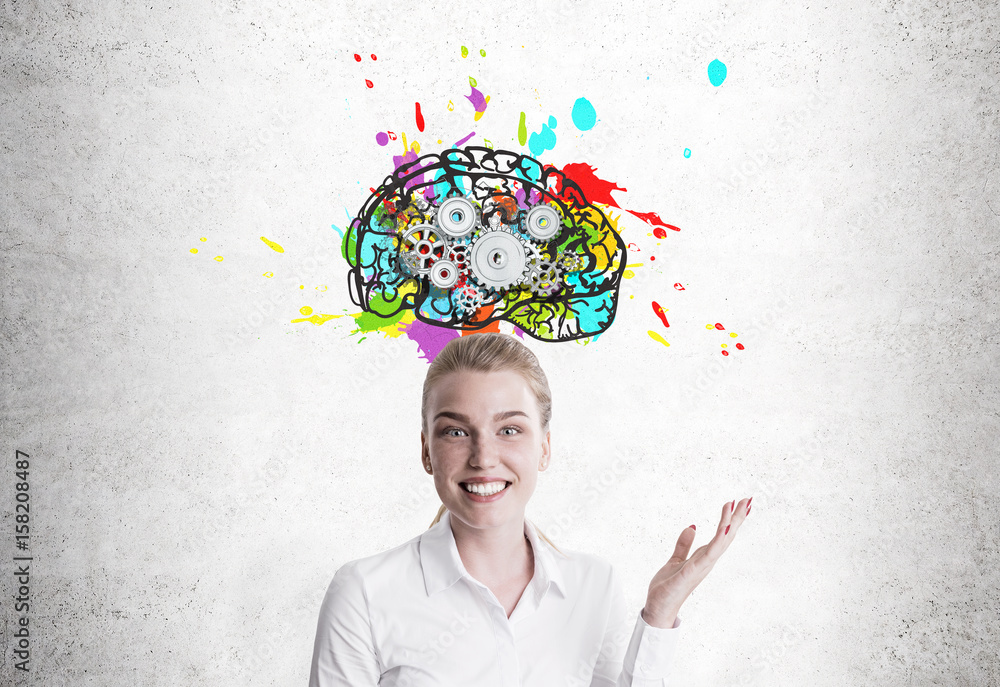 Smiling blond woman showing brain with cogs Smiling blond woman showing brain with cogs