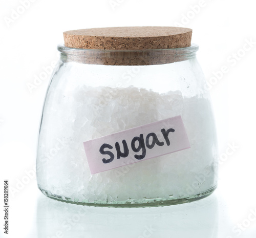 Obraz na plátně Glass jar with rock sugar isolated on white.