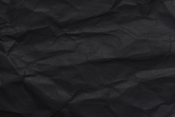 The background paper, crumpled black