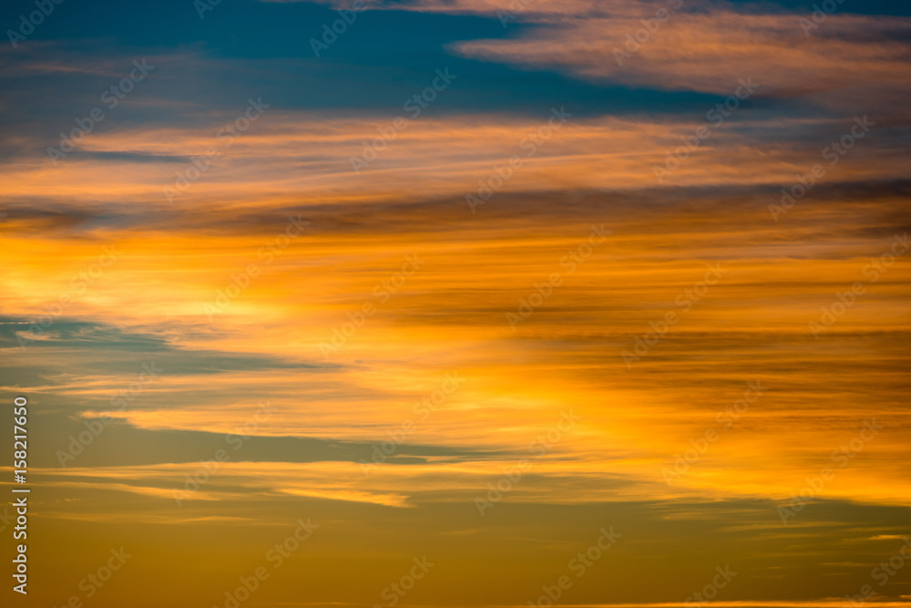 abstract colored sunset sky with broken clouds