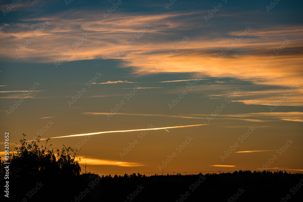 abstract colored sunset sky with broken clouds