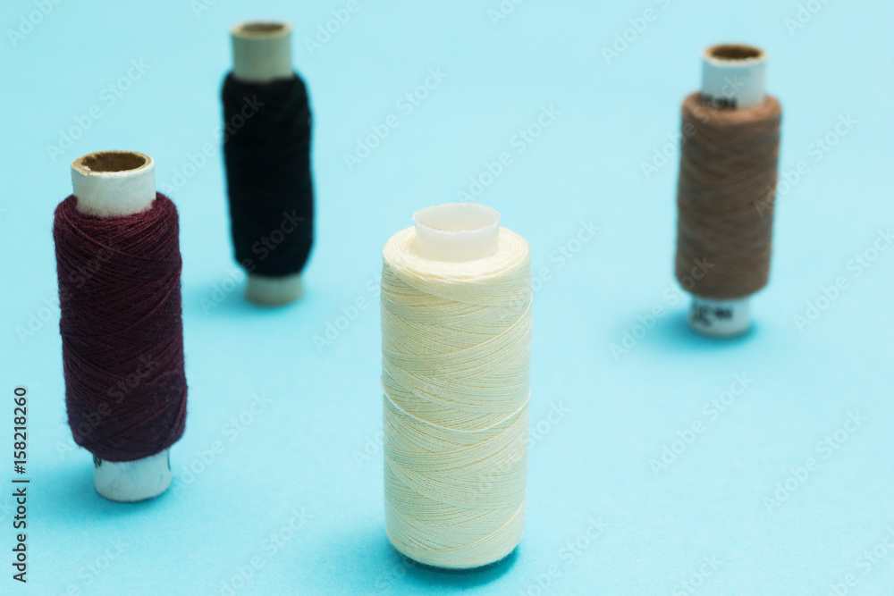 Background of old rolls of thread on a blue table. Background of old rolls of thread on a blue table.
