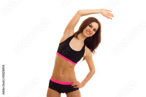 a young energetic fitness girl smiling and doing exercises is