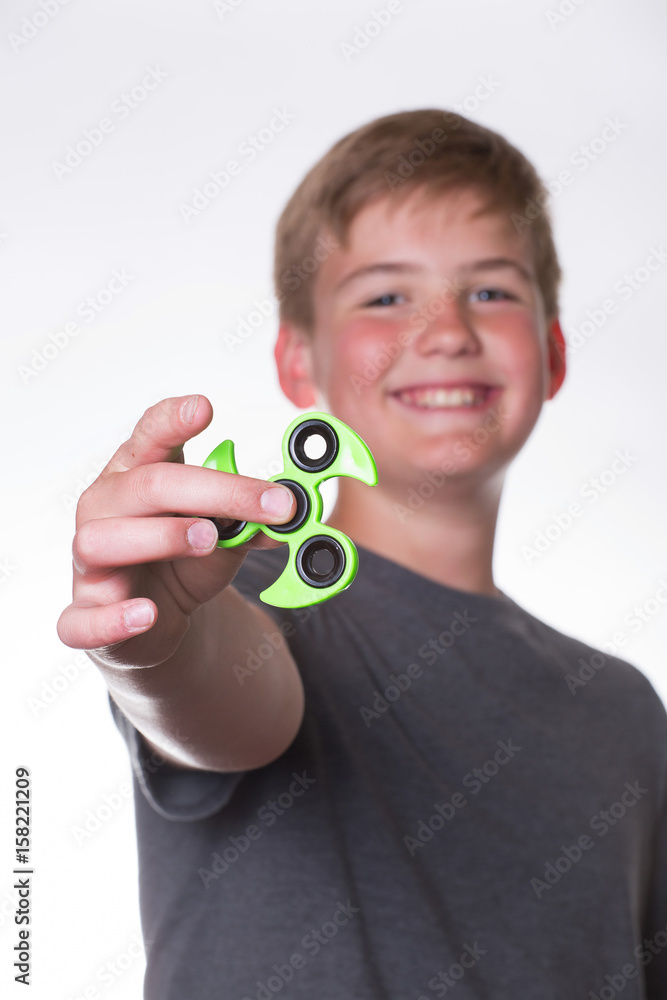 Fototapeta premium Boy holding out fidget spinner