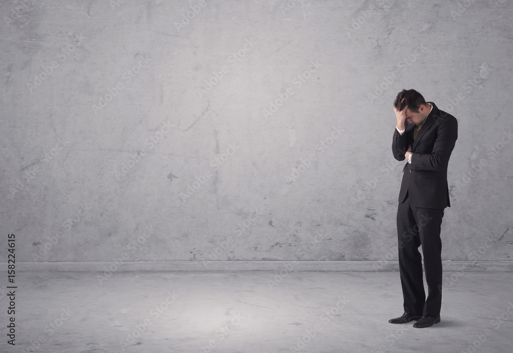 Young businessman standing confused Young businessman standing confused