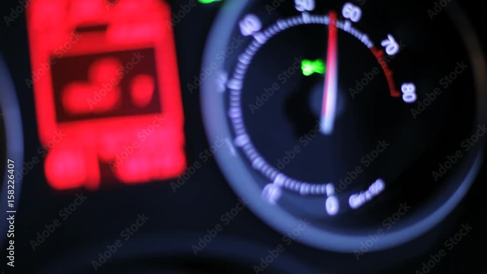 Tachometer arrow. Car dashboard at night. Car rpm. Driving fast at