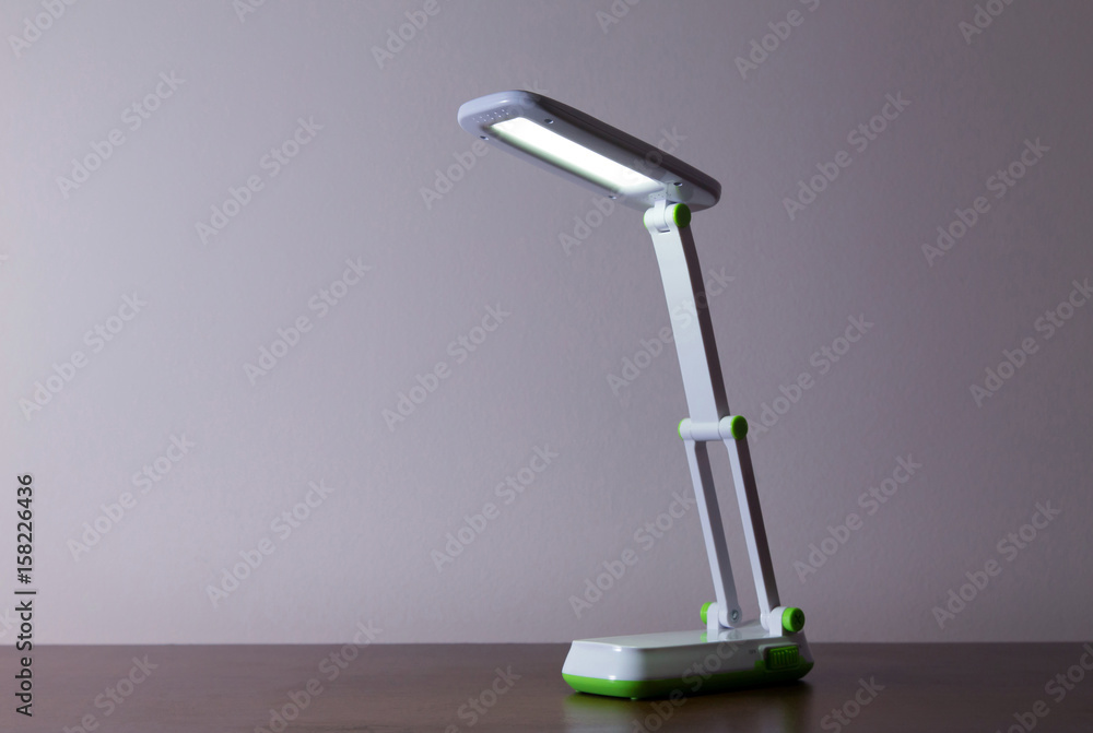 White table lamp
Closeup of a white LED lamp standing on a wooden table White table lamp
Closeup of a white LED lamp standing on a wooden table
