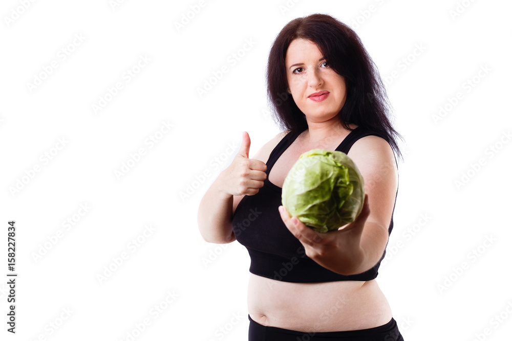 Food addiction, diet, overweight, healthcare, weight loosing, fitness, well-being concept. Young overweight woman agitating for healthy food with cabbage in hand and thumb up gesture Food addiction, diet, overweight, healthcare, weight loosing, fitness, well-being concept. Young overweight woman agitating for healthy food with cabbage in hand and thumb up gesture