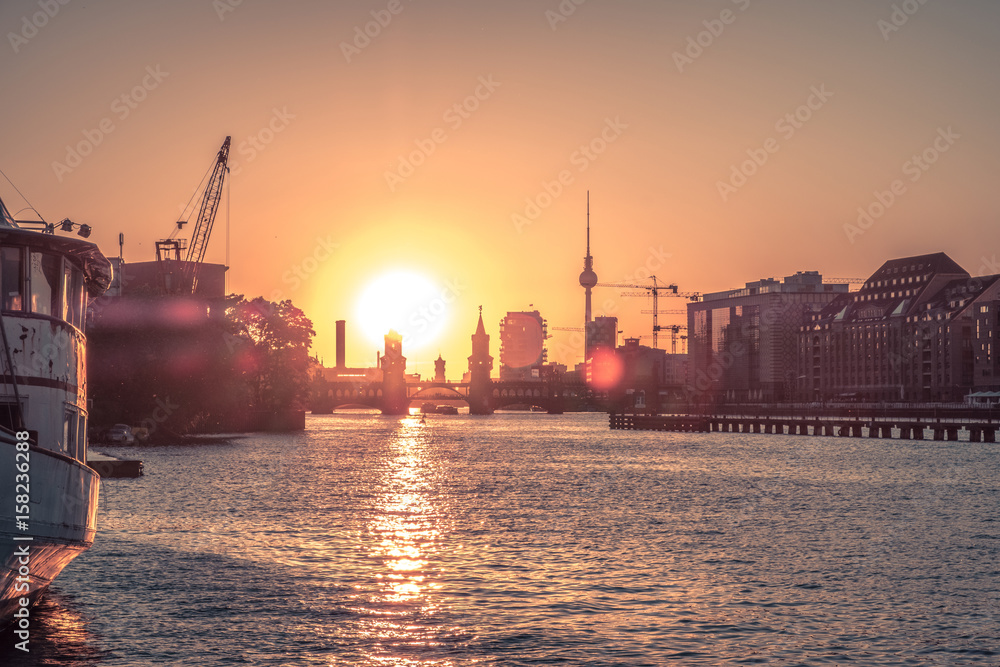 Berlin city skyline with sunset sky - river Spree, Oberbaum Bridge, Tv Tower