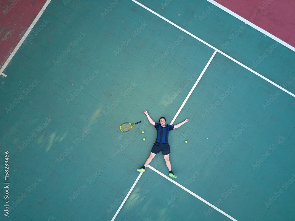 Tennis man player lay on court