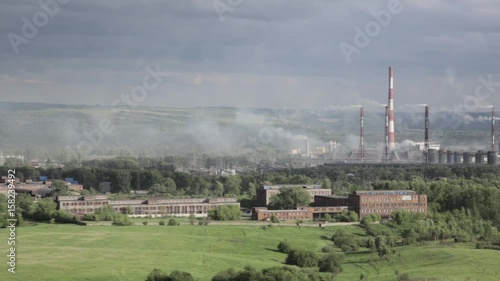 Air pollution above smole city. Pipes throwing smoke towards the city photo