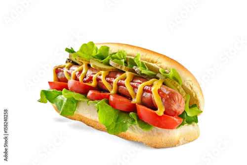 Classic Hot Dog with big sausage, fresh salad, tomatoes and pickled cucumbers isolated on white background photo