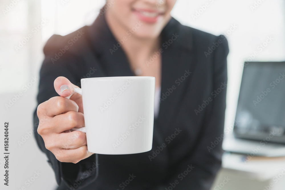 Beautiful young business woman with smile holding white coffee cup Beautiful young business woman with smile holding white coffee cup