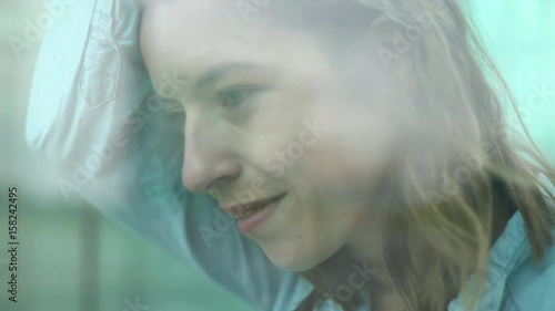 Woman leaning against window, daydreaming photo