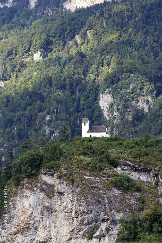 White chapel on the depth of high mountain, Canton St. Gallen Switzerland