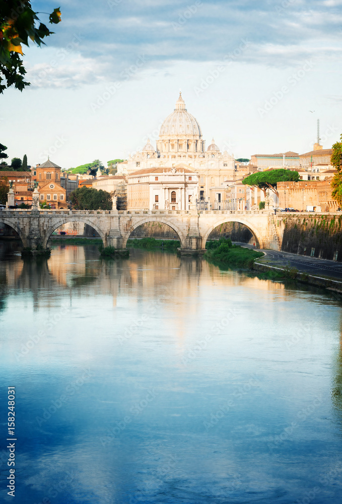 St. Peter's cathedral over bridge and river Tiber water in Rome, Italy, retro toned