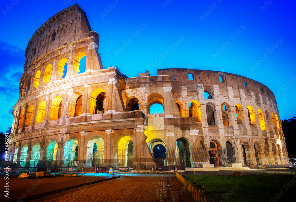 view of Colosseum illuminated at blue night in Rome, Italy, retro toned