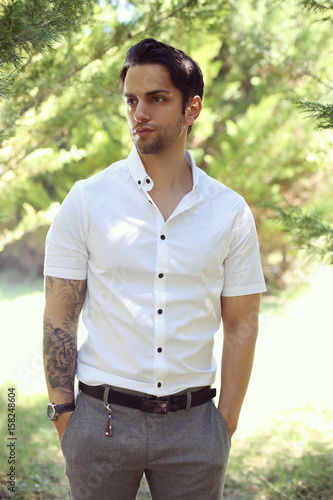 handsome man with a preppy style posing outdoor