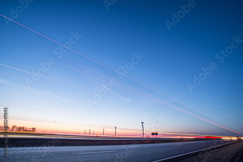 wind turbines at sunset along highway morning commute