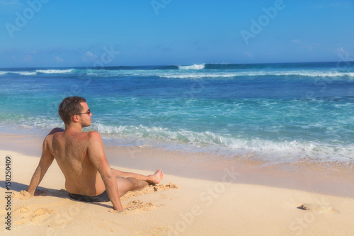 Man enjoying on empty tropical exotic beach.