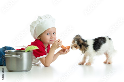 Role-playing game. Child boy playing chef with dog.