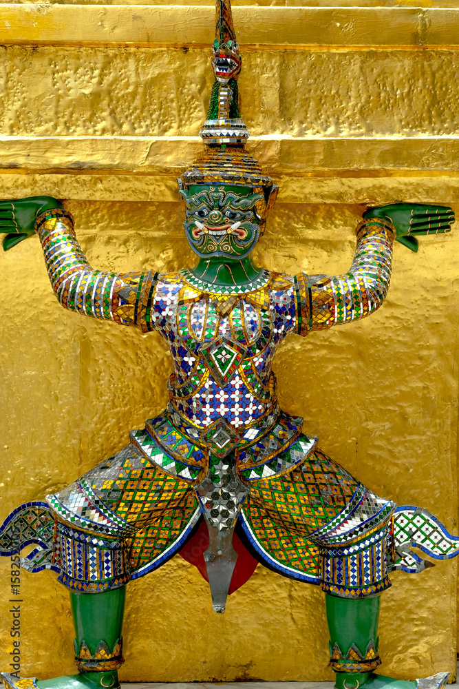 Demon Guardian/ Giant Statues stand around pagoda and hand to lift the base of the golden pagoda of thailand at wat phra kaew